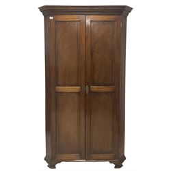Georgian design mahogany corner wardrobe, the projecting cornice over two panelled doors, opening to reveal interior fitted for hanging with one shelf, raised on ogee supports 
