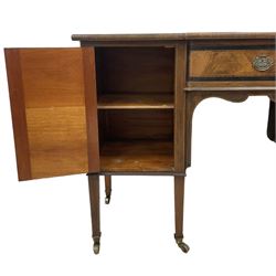 Early 19th century mahogany break-front kneehole dressing table or sideboard, figured top over central drawer and two cupboards, decorated with ebony bandings and boxwood stringing, the kneehole with shaped apron, on square tapering supports with brass cups and castors