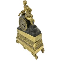 French early 19th century 8-day mantle clock, with a gilded figure of a  Turkish lady resting on a drum enclosed Parisian movement, on a broad decorated plinth resting on scroll feet, silvered dial with Roman numerals and steel moon hands, with a silk suspension and count wheel striking movement, striking the hours on a bell.