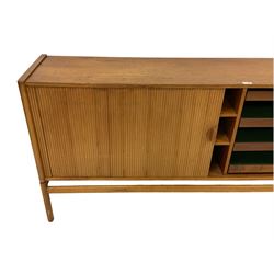 Mid 20th century teak sideboard, rectangular top over tambour sliding front enclosing four shelves and four sliding trays