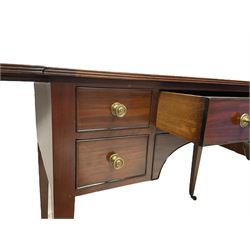 Regency mahogany drop-leaf side table, rectangular top with reeded edge supported by pull-out stays, fitted with central frieze drawer flanked by four small drawers, each with ebony cock-beaded facias and Sheraton design brass knobs, raised on square tapering supports with brass cups and castors