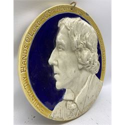 Leeds Pottery portrait plaque of Sir Henry Irving, modelled by C. Holding, with inscription 'Into Thy Hands O Lord' and with hand written inscriptions verso, D28.5cm 