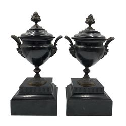 Pair of Victorian Classical black slate garnitures, each of urn form with bronze finial, handles and pedestal base, on square stepped bases, H30.5cm