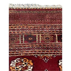 Afghan Bokhara rug, red ground and decorated with traditional Gul motifs, geometric design borders and end panels decorated with repeating decoration 