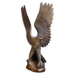 A very large carved wooden model of an Eagle with wings outstretched, H122cm x W64cm approx
