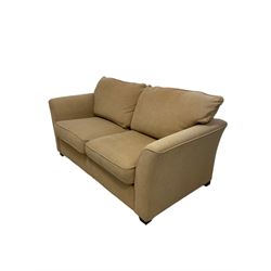 Two seat metal action sofa bed, upholstered in beige fabric