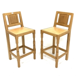 'Knightman' pair oak bar stools with panelled backs and leather upholstered seats, by Horace Knight workshop of Balk, Thirsk 