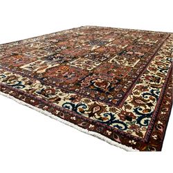 Persian Bakhtiari garden rug, the field divided into panels each decorated with floral designs and tree of life motifs, the border decorated with scrolls and stylised peony motifs, within guards