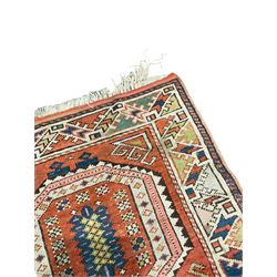 Turkish orange ground rug, two medallions decorated with geometric motifs, geometric design border