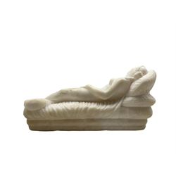 Carved alabaster nude figure reclining on a day bed, a dog at her feet L24cm