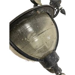 Three outdoor wall lights, domed form with glass shades and scrolled decoration