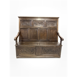 18th century and later joined oak hall settle, panelled back over open arms and hinged seat revealing storage compartment, carved with 'S' scroll decoration, stile supports 
