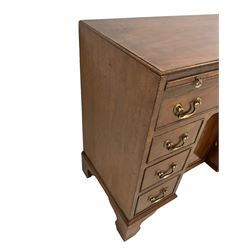 George III mahogany kneehole desk or dressing table, moulded rectangular top over slide with baize lining, single long drawer, six short drawers and cupboard, the drawers and cupboard door with cock-beading, on bracket feet