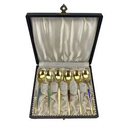 Set of six Danish sterling silver gilt coffee spoons each with a different coloured enamelled stem, cased 