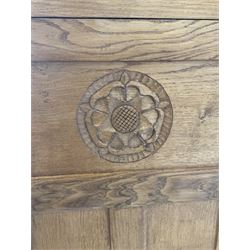 'Gnomeman' adzed oak corner cupboard, fitted with one lead glazed door enclosing two loose shelves over one panelled door with carved Yorkshire rose enclosing one loose shelf, carved with gnome signature, by Thomas Whittaker of Little Beck