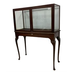 20th century glazed museum display cabinet, enclosed by two doors, raised on cabriole supports with pad feet