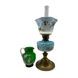 Table oil lamp with glass reservoir and shade and a Mary Gregory style green glass jug