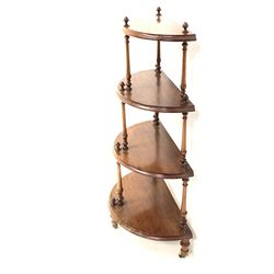 Victorian walnut demi lune whatnot, with four graduated tiers raised on spindle supports, terminating in brass and ceramic castors H103cm
