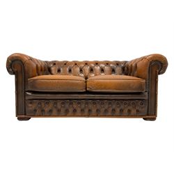 Small two seat chesterfield settee, upholstered in buttoned tan leather with studwork 