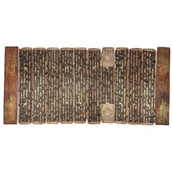 Burmese kammavaca manuscript, consisting of two lacquered wooden covers and ten double-sided folios with black, red and gold lacquer, L55cm x W10cm