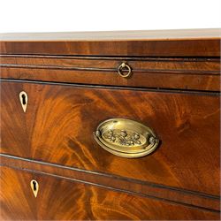 Georgian mahogany bachelor's chest, fitted with slide over three graduating drawers with figured and matched fronts, boxwood and ebony stringing, on shaped apron and splayed bracket feet, with bone escutcheons  