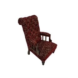 Victorian style armchair, upholstered in floral fabric, raised on turned supports 