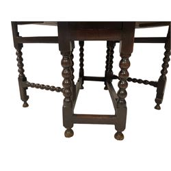 18th century drop-leaf oak dining table, oval top fitted with two drawers, raised on bobbin-turned supports with double gate-leg action, united by stretchers with carved rails