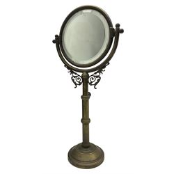 Early 20th century telescopic brass shaving mirror, of tubular form with bevelled glass plate and scroll details, H50cm 