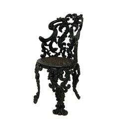 Late 19th century painted heavy ornate cast iron garden chair, the cartouche scrolled cresting rail over pierced foliate design back with trailing scrolls, the seat with pierced geometric fretwork