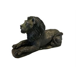 Composite garden statue, modelled as a recumbent lion with outstretched paws