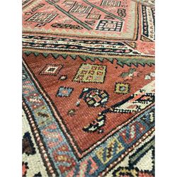 Persian runner rug, with two medallions, red field and ivory border 233cm x 112cm