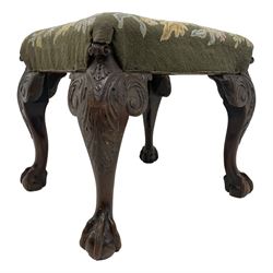 19th century George II style walnut stool, the top upholstered in floral needlework cover, scrolled acanthus leaf and bellflower carved cabriole supports with projecting scroll carved terminal, ball and claw carved feet