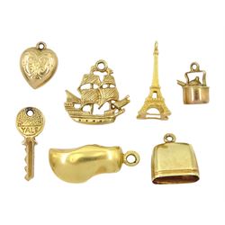Gold pendant/charms including two 18ct Eiffel tower and clog, 14ct flower cow's bell, 15ct ship and three 9ct key, heart and kettle