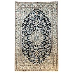 Fine Persian Nain ivory ground rug, wool with silk inlay, central pole medallion within an indigo field decorated with scrolling palmettes, the contrasting spandrels with floral patterns, the guarded border with repeating plant motifs