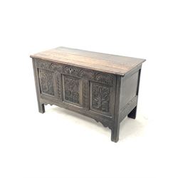18th century oak coffer, the hinged lid over lunette carved frieze and three floral carved panelled front, raised on stile supports W115cm, H73cm, D54cm