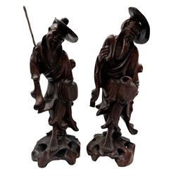 Pair of Chinese carved standing figures of farmers on rockwork bases H30cm