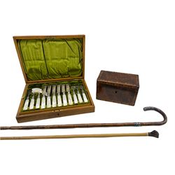 Set of twelve plated dessert knives and forks with engraved blades and mother of pearl handles, cased, early 19th century mahogany tea caddy with chevron banding and two walking sticks