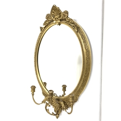 Late 19th century gilt wood and gesso framed wall mirror, anthemion pediment above oval mirror plate and three branch candle scone, 54cm x 89cm