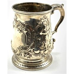 Early George III silver mug with vacant cartouche and embossed decoration with leaf capped handle H10cm London 1769 Maker possibly John Swift 7oz