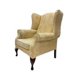 20th century wingback armchair, upholstered in ivory floral damask, raised on cabriole front supports 
