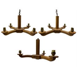 Acornman - pair of four-branch oak ceiling lights and another with three-branches, by Alan Grainger of Brandsby, York, max L49cm (3)