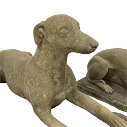 Pair of cast stone garden statues in the form of recumbent greyhounds, on rectangular plinth bases