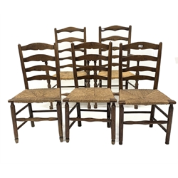 Set of five (2+3) oak ladderback dining chairs, with rush seats, raised on turned supports and stretchers, W62cm