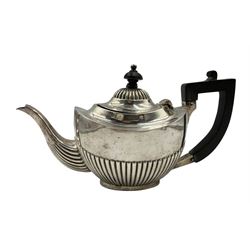 Edwardian silver bachelors teapot of oval form with half body decoration, ebonised handle and lift Birmingham 1906 Maker Henry Matthews 