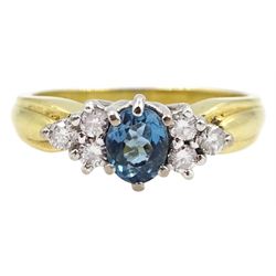 18ct gold oval blue topaz and six stone round brilliant cut diamond cluster ring,