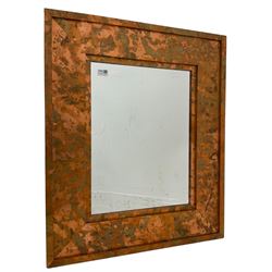Copper framed mirror, rectangular bevelled plate, the wide stepped frame with an iridescent finish