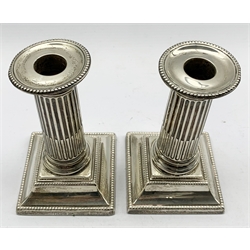 Pair of Edwardian silver table candlesticks with reeded columns on stepped square bases H13cm Sheffield 1905 Maker Walker and Hall