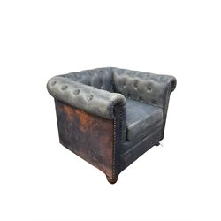 Chesterfield chair, upholstered in blue leather with buttoned back and arms, raised on turned supports 