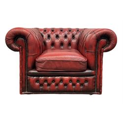 Red chesterfield armchair, buttoned back and arms with one squab cushion, raised on brass castors