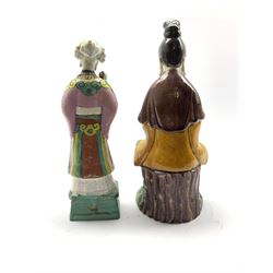 Chinese Sancai glazed figure depicting Guanyin H24.5cm together with a Chinese Famille-Rose figure of an immortal wearing a pink robe (2)